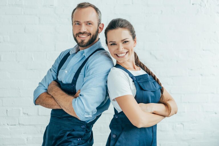 smiling confident workers in uniform posing with crossed arms